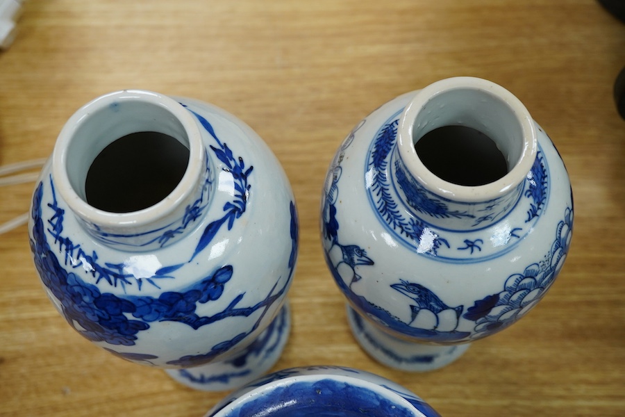 A pair of Chinese blue and white vases and a baluster jar and cover, largest 23cm high